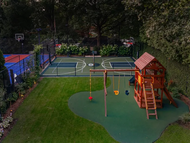 Elevated twilight view of a sport court and playground