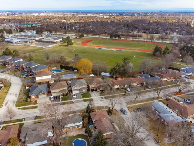 Aerial of a suburb and sports field in autumn