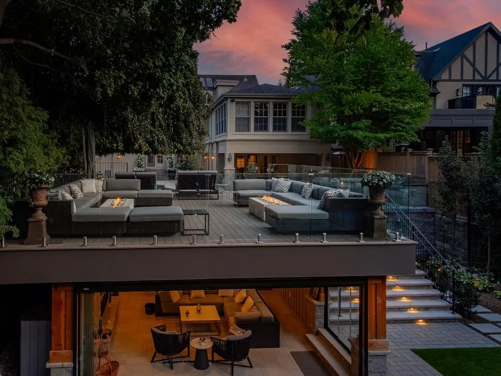 Twilight rooftop lounge above lit pavilion